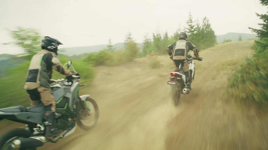 Two dirt bikes on a forest trail
